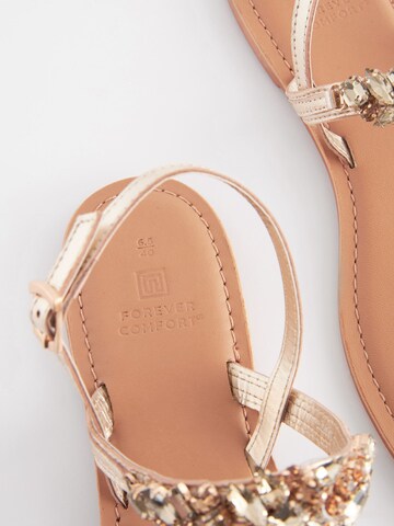 Next Teenslipper in Goud