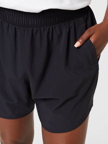 UNDER ARMOUR Loose fit Sports trousers in Black
