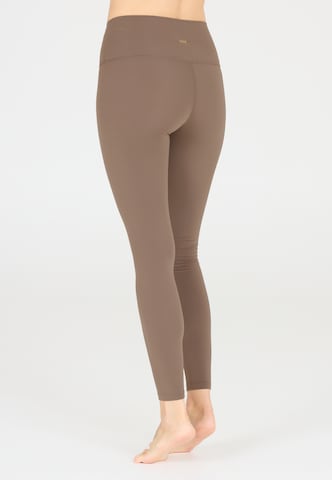 Athlecia Skinny Sportbroek 'Snyder' in Bruin