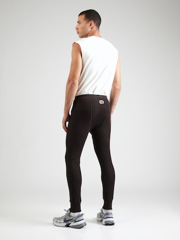 Nike Sportswear Zwężany krój Spodnie 'BODE REC' w kolorze brązowy: tył