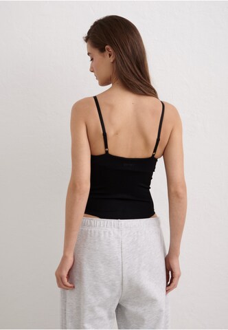 Body de sport Aim'n en noir