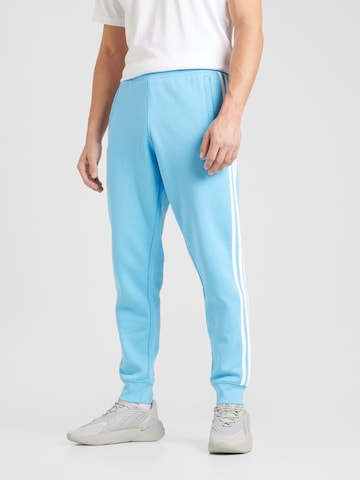 ADIDAS ORIGINALS Tapered Trousers in Blue: front