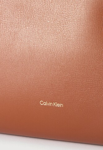 Plase de cumpărături de la Calvin Klein pe maro