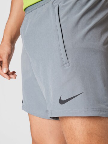 NIKE Regular Workout Pants in Grey