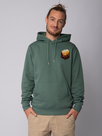 Felpa 'Hiking in the mountains' di Watapparel in verde: frontale