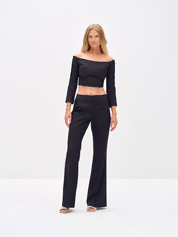 ABOUT YOU x Toni Garrn Flared Trousers with creases 'Elonie' in Black