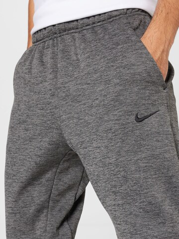 NIKE Tapered Sports trousers in Grey