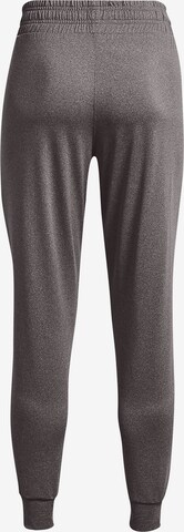 Effilé Pantalon de sport UNDER ARMOUR en gris