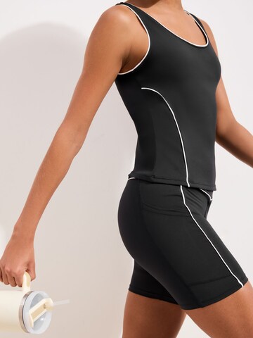 Skinny Pantaloni sportivi di Friends Like These in nero