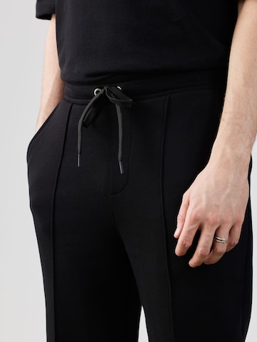 ABOUT YOU x Rewinside Tapered Pants in Black