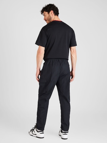 Tapered Pantaloni cu buzunare 'AIR' de la Nike Sportswear pe negru