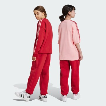 ADIDAS ORIGINALS Tapered Trousers in Red