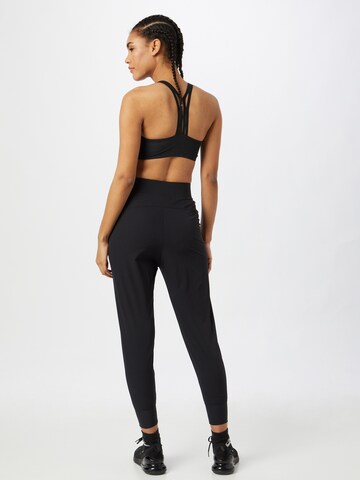 Effilé Pantalon de sport 'Bliss Luxe' NIKE en noir