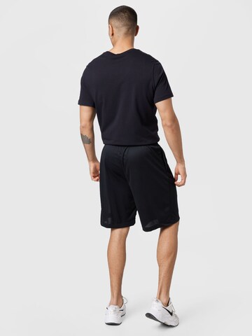 NIKE - Pierna ancha Pantalón deportivo en negro