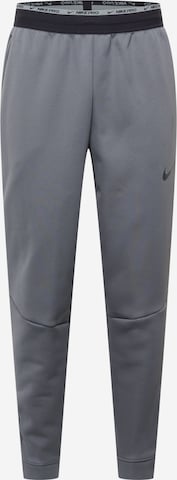 NIKE Tapered Sports trousers in Grey: front