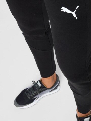 PUMA - Tapered Calças de desporto 'Evostripe' em preto