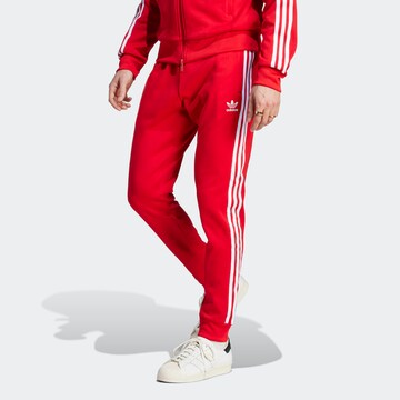 ADIDAS ORIGINALS Tapered Housut 'Adicolor Classics Sst' värissä punainen