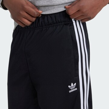 ADIDAS ORIGINALS Tapered Housut 'Adicolor' värissä musta
