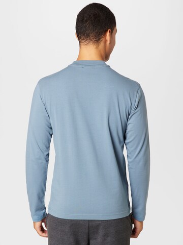 Calvin Klein قميص بلون أزرق
