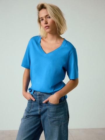 zils Next T-Krekls: no priekšpuses