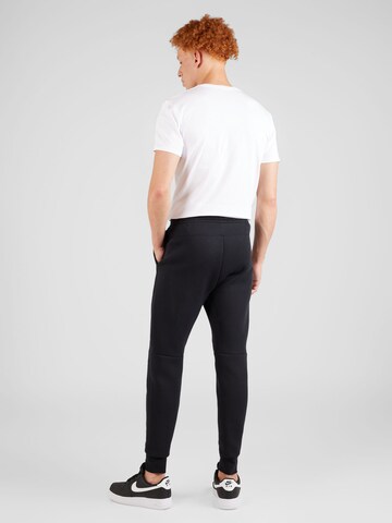 Nike Sportswear Zúžený Kalhoty 'TECH FLEECE' – černá