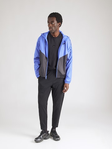 Tapered Pantaloni sport 'HERITAGE' de la NIKE pe negru