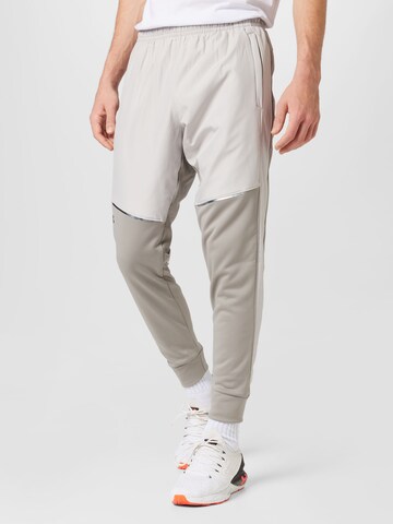 UNDER ARMOUR Tapered Sportnadrágok 'Storm' - bézs: elől