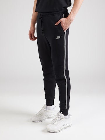 Nike Sportswear Tapered Trousers in Black: front