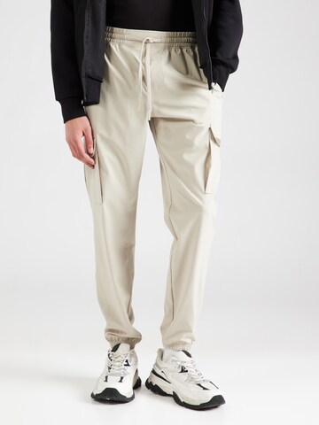 UNDER ARMOUR Tapered Sports trousers 'Vibe' in Beige: front