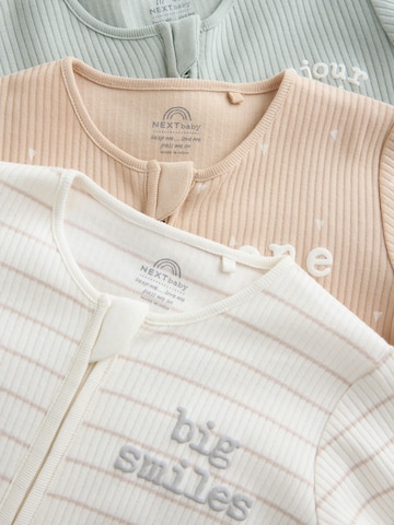 Pijamale de la Next pe bej