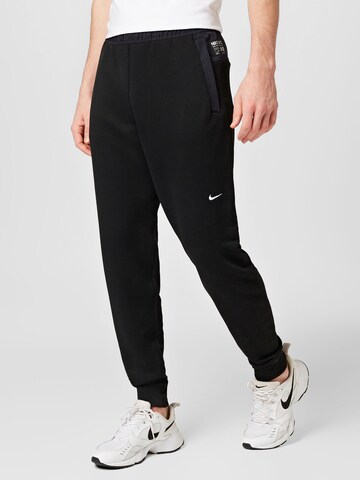 NIKE Tapered Sports trousers in Black: front