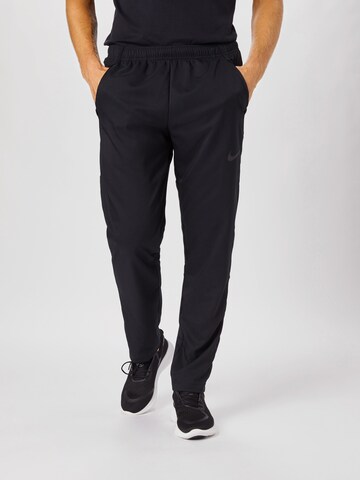 NIKE Regular Workout Pants 'Dry Woven' in Black: front