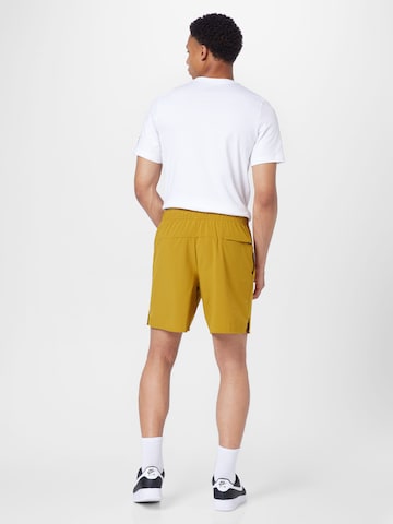 NIKE Regular Workout Pants 'Unlimited' in Yellow