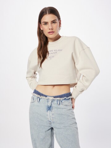 Sweat-shirt Calvin Klein Jeans en beige : devant