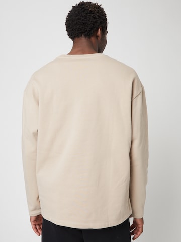 Sweat-shirt ABOUT YOU x Louis Darcis en beige