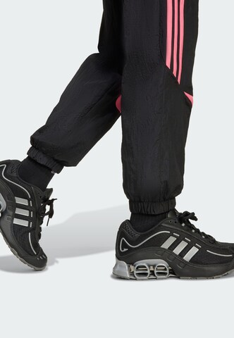 Tapered Pantaloni 'Teamgeist' di ADIDAS ORIGINALS in nero