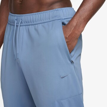 NIKE Tapered Workout Pants in Blue