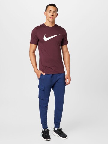 Tapered Pantaloni cu buzunare de la Nike Sportswear pe albastru