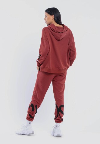 Tom Barron Sports Suit 'Chaos' in Red