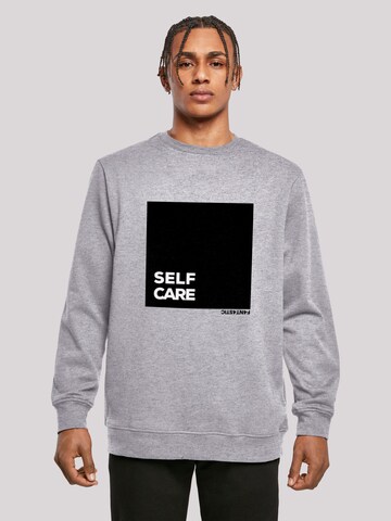 Sweat-shirt 'SELF CARE' F4NT4STIC en gris : devant