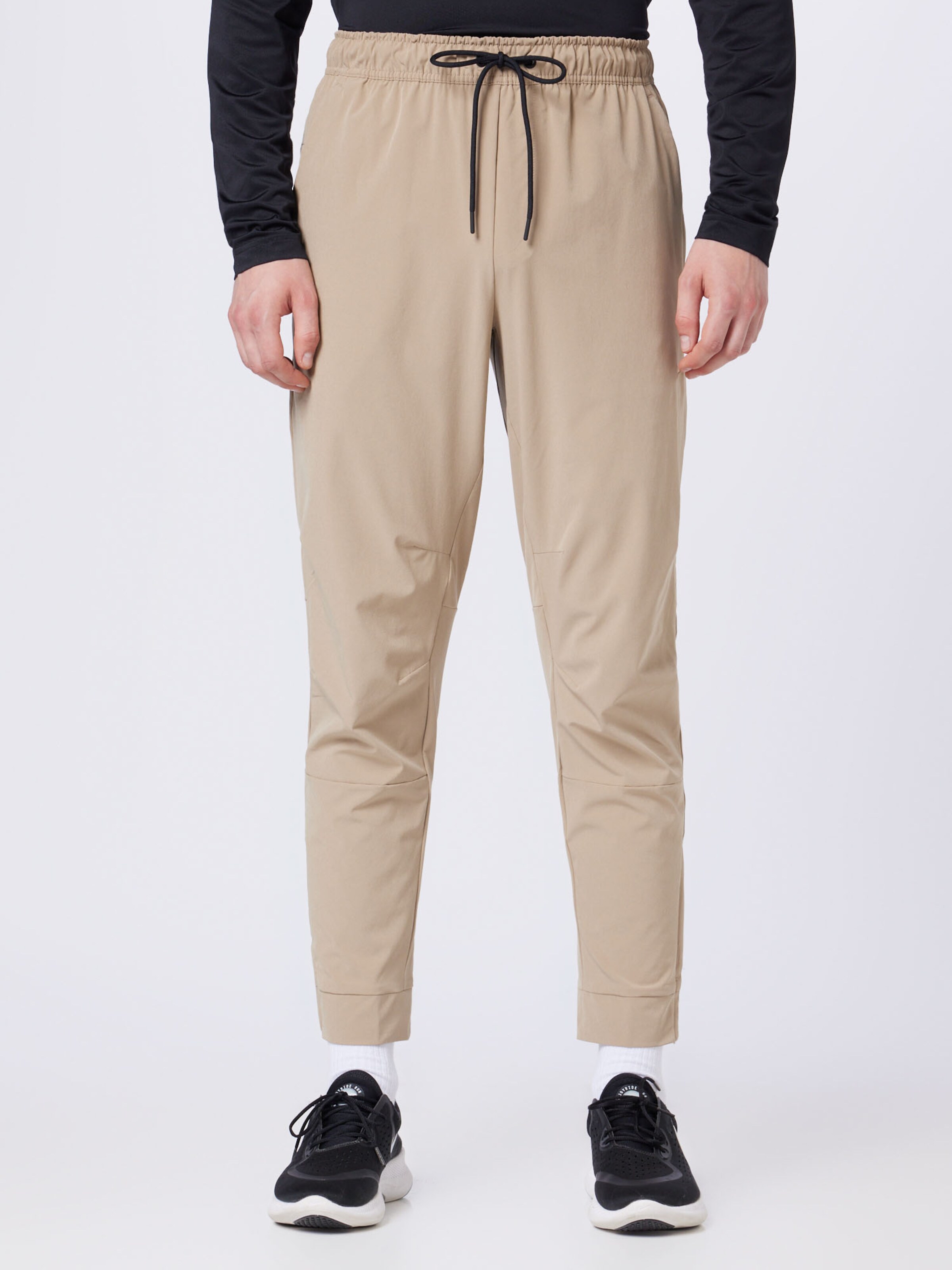 NIKE Tapered Workout Pants Unlimited in Khaki ABOUT YOU
