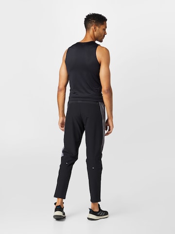 Coupe slim Pantalon de sport 'Own The Run Colorblock' ADIDAS SPORTSWEAR en noir