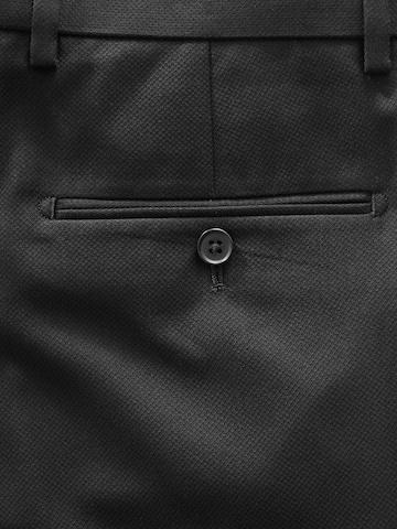 Skinny Pantaloni con piega frontale di Next in nero