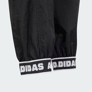 ADIDAS SPORTSWEAR Lużny krój Spodnie sportowe 'Dance Woven' w kolorze czarny