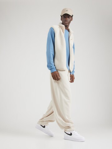 Effilé Pantalon 'CLUB' Nike Sportswear en beige