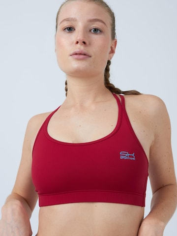 SPORTKIND - Sujeción media Sujetador deportivo 'Crossed Straps' en rojo: frente