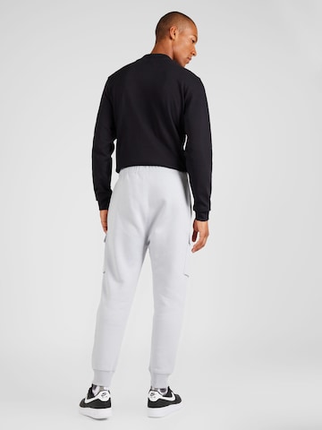 Nike SportswearTapered Cargo hlače - siva boja