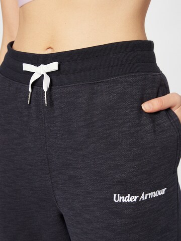 UNDER ARMOUR Tapered Sports trousers in Black
