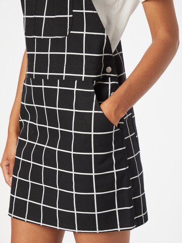 Obey Dungaree skirt in Black