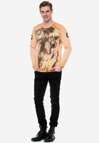 Rusty Neal Langarmshirt mit coolem Front- Print in Orange